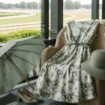 A floral dress draped across a wooden chair on a shaded veranda
